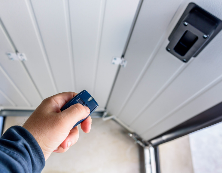 A garage door technician with a remote control 